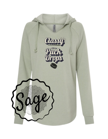 Light gray hoodie with 'Classy When the Puck Drops' text and a hockey puck graphic, labeled 'Sage'.