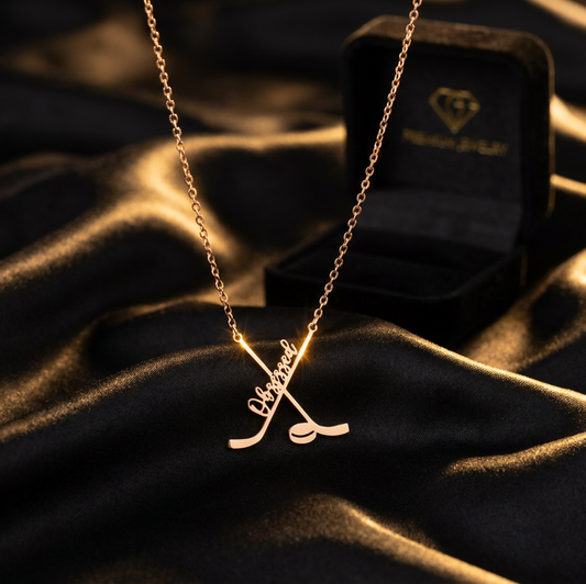 Gold necklace with a pendant on a textured black surface