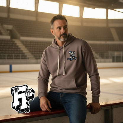 Frozen Threads Clothing taupe unisex hoodie with a Skelly hockey patch on the chest, jersey-lined hood, and front pouch pocket.
